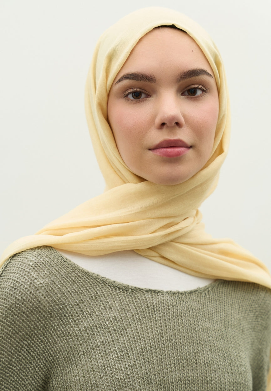 Detail shot of Yellow Cashmere Textured Scarf Butter fabric and stitching