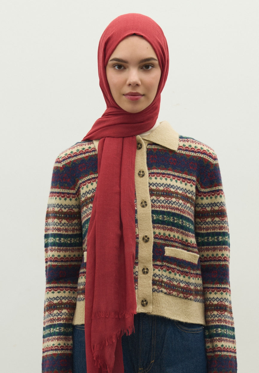 Detail shot of Rejection Cashmere Textured Scarf Red fabric and stitching